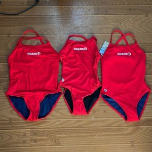 Three lifeguard bathing suits. One brand new, two gently used.